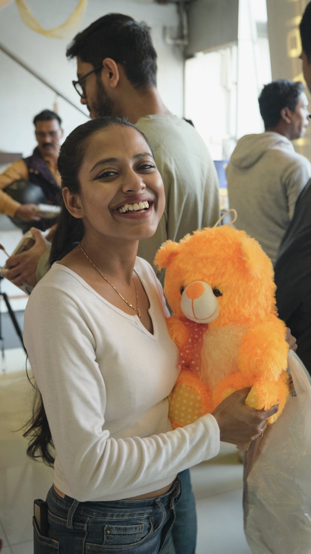 A Tikii team member smiling while holding an orange plush toy