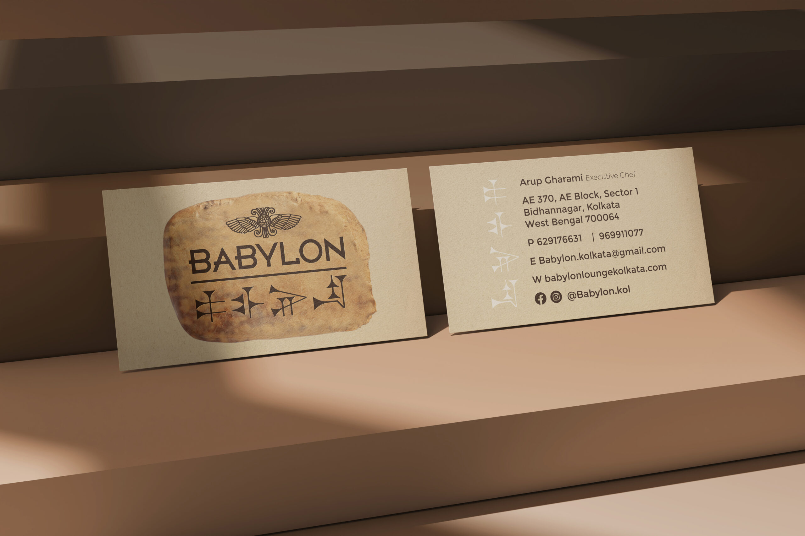 Front and back of a Babylon business card on a display shelf