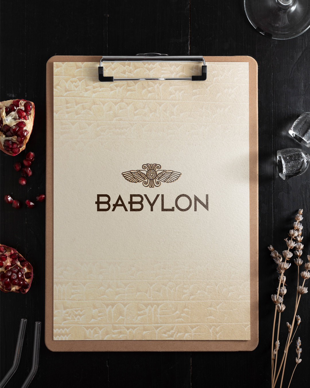 Babylon menu cover on a clipboard with pomegranate and lavender