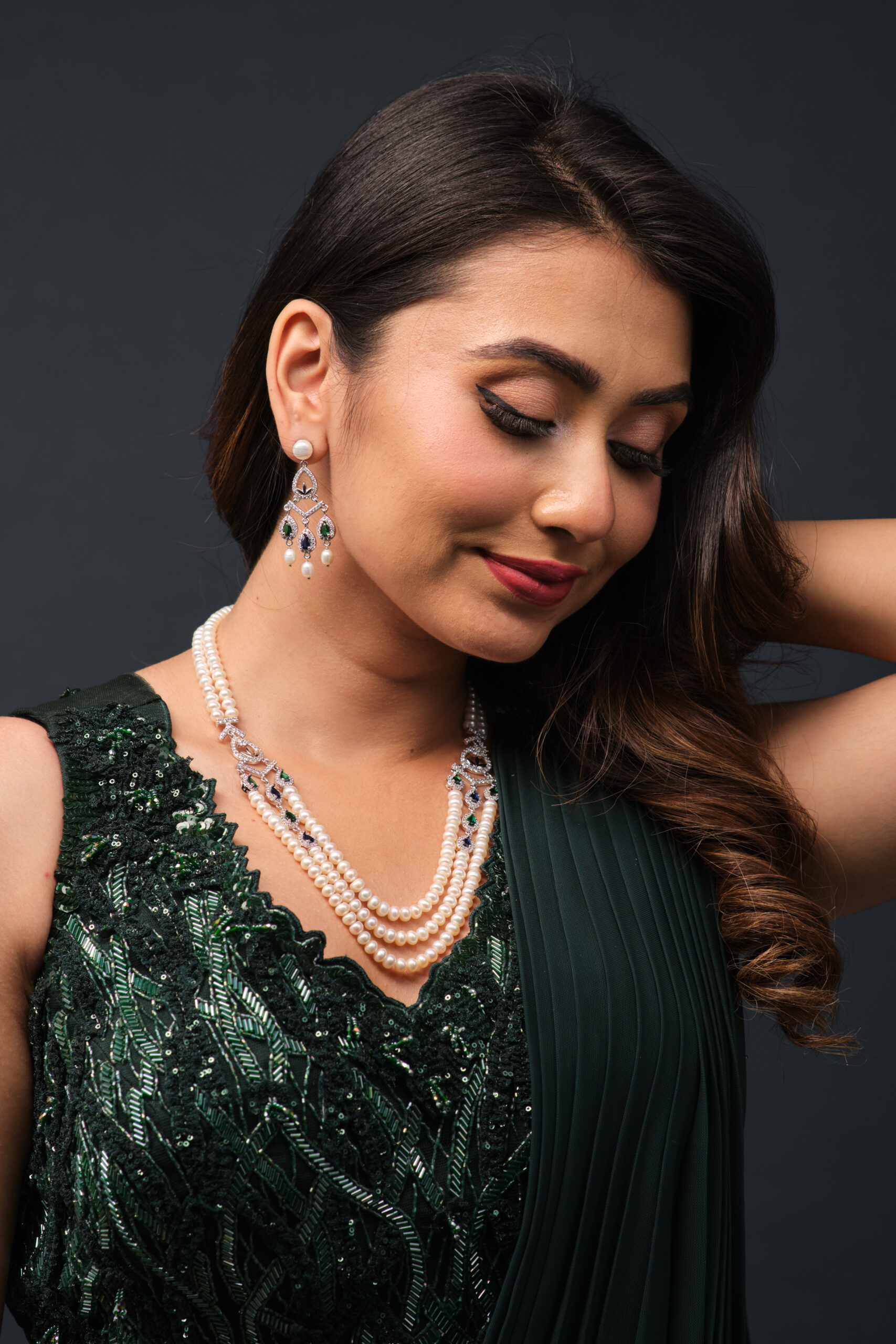 Model wearing a layered pearl necklace and matching jewellery