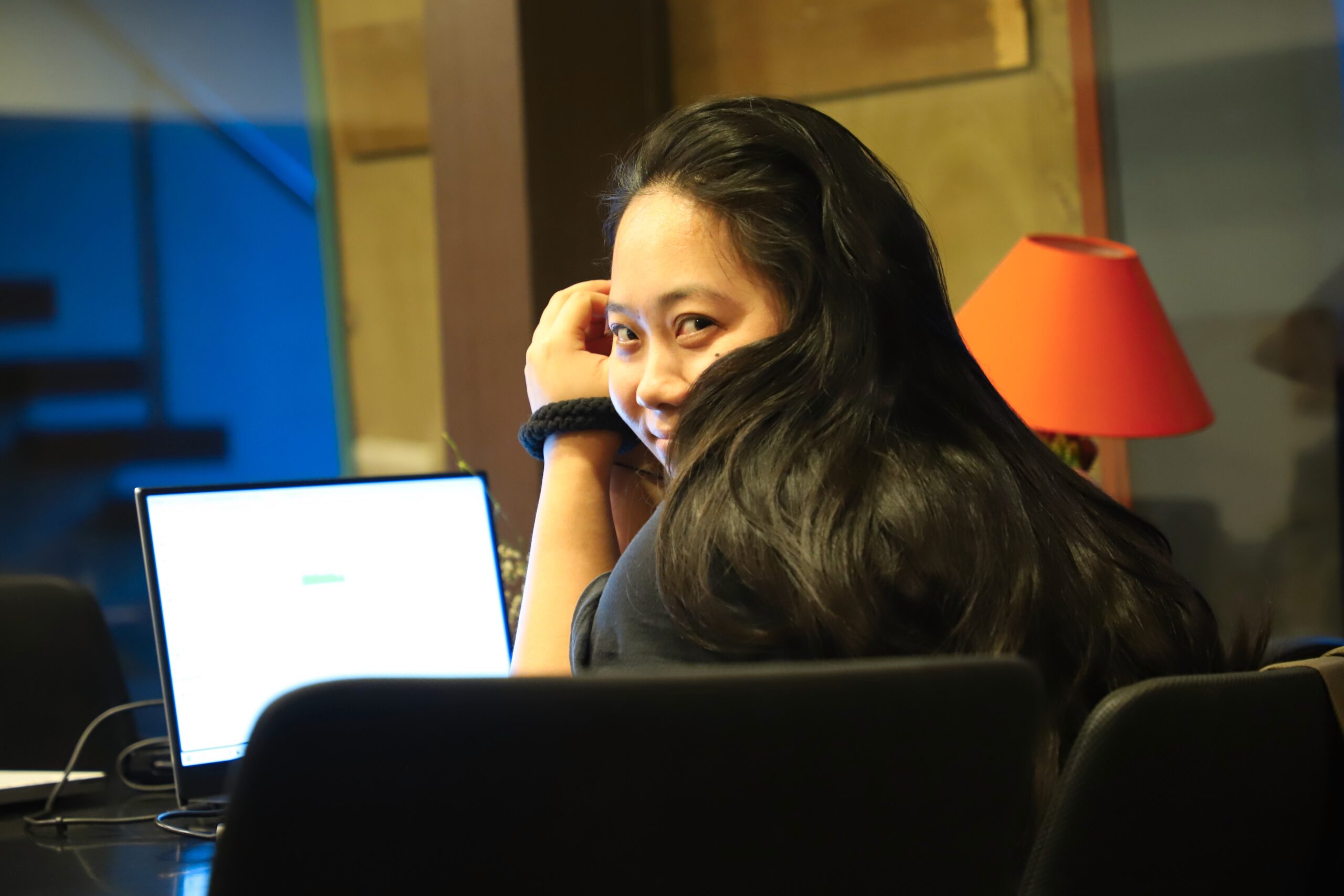 A Tikii team member working at a laptop in the studio