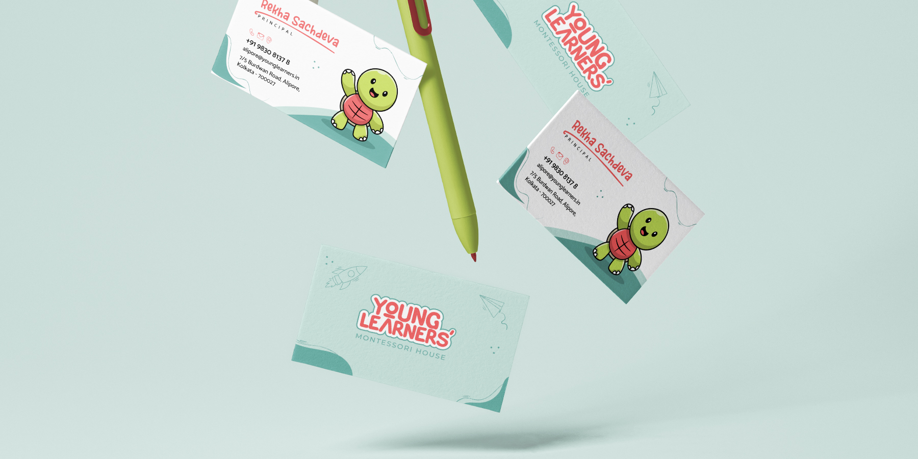 Young Learners business cards arranged around a green pen